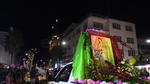 Carros alegóricos adornados con globos, banderas mexicanas y  con imágenes de la virgen sobresaliendo en ellos.