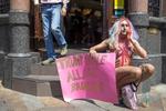Una drag queen posa con una pancarta durante una protesta en contra del presidente de los Estados Unidos.