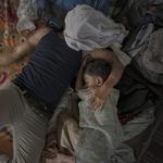 Un padre y su hijo durmiendo después de un largo d?a de caminar, en Juchitán, por Pieter Ten Hoopen