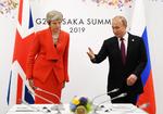 Putin y la primera ministra británica, Theresa May.