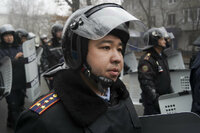 A riot police officer stands ready to stop demonstrators during a protest in Almaty, Kazakhstan, Wednesday, Jan. 5, 2022. Demonstrators denouncing the doubling of prices for liquefied gas have clashed with police in Kazakhstan's largest city and held protests in about a dozen other cities in the country. (AP Photo/Vladimir Tretyakov)