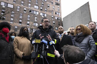 New York City Mayor Eric Adams, middle, speaks during a news conference outside an apartment building where a deadly fire occurred in the Bronx on Sunday, Jan. 9, 2022, in New York. (AP Photo/Yuki Iwamura)
