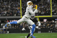 Los Angeles Chargers wide receiver Mike Williams (81) makes a catch against the Las Vegas Raiders during the second half of an NFL football game, Sunday, Jan. 9, 2022, in Las Vegas. (AP Photo/David Becker)