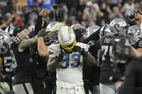 Los Angeles Chargers defensive tackle Justin Jones (93) removes his helmet after the Los Angeles Chargers lost to the Las Vegas Raiders in overtime of an NFL football game, Sunday, Jan. 9, 2022, in Las Vegas. (AP Photo/David Becker)