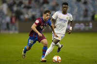 Barcelona's Gavi in action in front of Real Madrid's Vinicius Junior during the Spanish Super Cup semi final soccer match between Barcelona and Real Madrid at King Fahd stadium in Riyadh, Saudi Arabia, Wednesday, Jan. 12, 2022. (AP Photo/Hassan Ammar)