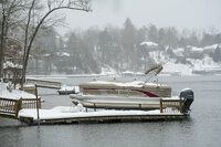 Boats and docks were covered in snow on Lake James, during a winter storm, Sunday, Jan. 16, 2022 in Morganton, N.C. Visibility was at a minimum as ice, snow and wind swept through the area. (AP Photo/Kathy Kmonicek)