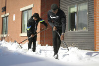 Deshawn Coleman, 18, left, and Evonte McGee, 17, both of Des Moines, Iowa, shovel a sidewalk outside a senior living facility during a Martin Luther King, Jr., Day of Service event hosted by the Des Moines Urban Dreams organization on Monday, Jan. 17, 2022. Many central Iowans are still digging out after a recent storm dumped nearly a foot of snow. (Bryon Houlgrave/The Des Moines Register via AP)