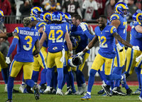 Los Angeles Rams players, including wide receiver Odell Beckham Jr. (3), long snapper Matthew Orzech (42) and wide receiver Van Jefferson (12) celebrate after defeating the Tampa Bay Buccaneers in a NFL divisional round playoff football game, Sunday, Jan. 23, 2022, in Tampa, Fla. (AP Photo/John Raoux)