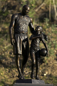 A bronze sculpture honoring former Los Angeles Lakers NBA basketball player Kobe Bryant, his daughter Gianna Bryant, and the names of those who died, is displayed at the site of a 2020 helicopter crash in Calabasas, Calif, on Wednesday, Jan. 26, 2022. (AP Photo/Ringo H.W. Chiu)