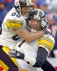 FILE - Pittsburgh Steelers quarterback Ben Roethlisberger (7) celebrates his 4-yard fourth quarter touchdown run with receiver Hines Ward in the AFC Championship football game against the Denver Broncos, Sunday, Jan. 22, 2006, in Denver. The Steelers advance to Super Bowl XL with a 34-17 win over Denver. Ben Roethlisberger's NFL career is over. The longtime Pittsburgh Steelers quarterback announced his retirement on Thursday, Jan. 27, 2022, saying it was “time to clean out my locker, hang up my cleats” after 18 years, two Super Bowls, countless team records and a spot in the Hall of Fame all but secure. (AP Photo/David Zalubowski, File)