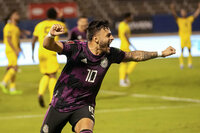 Mexico's Alexis Vega (10) celebrates with teammates after scoring his side's second goal against Jamaica during a qualifying soccer match for the FIFA World Cup Qatar 2022 in Kingston, Jamaica, Thursday, Jan. 27, 2022. (AP Photo/Ramon Espinosa)
