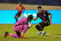 Jamaica's goalkeeper Andre Blake blocks a shot from Mexico's Carlos Antuna during a qualifying soccer match for the FIFA World Cup Qatar 2022 in Kingston, Jamaica, Thursday, Jan. 27, 2022. (AP Photo/Ramon Espinosa)
