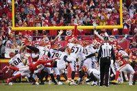 Kansas City Chiefs running back Darrel Williams (31) walks off the field with teammate Chris Jones (95) at the end of the AFC championship NFL football game against the Cincinnati Bengals, Sunday, Jan. 30, 2022, in Kansas City, Mo. The Bengals won 27-24 in overtime. (AP Photo/Charlie Riedel)