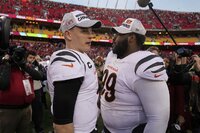 Cincinnati Bengals quarterback Joe Burrow (9) celebrates with teammate Tyler Shelvin at the end of the AFC championship NFL football game against the Kansas City Chiefs, Sunday, Jan. 30, 2022, in Kansas City, Mo. The Bengals won 27-24 in overtime. (AP Photo/Charlie Riedel)