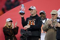 Cincinnati Bengals quarterback Joe Burrow, left, celebrates with teammate Tyler Shelvin, right, at the end of the AFC championship NFL football game against the Kansas City Chiefs, Sunday, Jan. 30, 2022, in Kansas City, Mo. The Bengals won 27-24 in overtime. (AP Photo/Charlie Riedel)