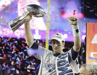 FILE - New England Patriots' Tom Brady raises the Vince Lombardi Trophy after defeating the Atlanta Falcons in overtime at the NFL Super Bowl 51 football game, in Houston, Feb. 5, 2017. Tom Brady has retired after winning seven Super Bowls and setting numerous passing records in an unprecedented 22-year-career. He made the announcement, Tuesday, Feb. 1, 2022, in a long post on Instagram. (AP Photo/Darron Cummings, File)