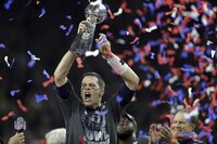 New England Patriots quarterback Tom Brady celebrates with the Vince Lombardi Trophy after the NFL Super Bowl XLIX football game against the Seattle Seahawks Sunday, Feb. 1, 2015, in Glendale, Ariz.  The Patriots won 28-24. (AP Photo/Michael Conroy)