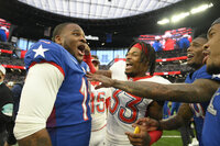 AFC quarterback Patrick Mahomes, right, of the Kansas City Chiefs, greets NFC inside linebacker Micah Parsons, center, of the Dallas Cowboys, after the Pro Bowl NFL football game at Allegiant Stadium, Sunday, Feb. 6, 2022, in Las Vegas. (AP Photo/David Becker)