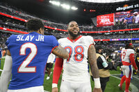 AFC quarterback Patrick Mahomes, right, of the Kansas City Chiefs, greets NFC inside linebacker Micah Parsons, center, of the Dallas Cowboys, after the Pro Bowl NFL football game at Allegiant Stadium, Sunday, Feb. 6, 2022, in Las Vegas. (AP Photo/David Becker)