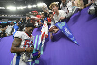 NFC cornerback Darius Slay (2), of the Philadelphia Eagles, greets AFC lineman Jeffery Simmons (98), of the Tennessee Titans, after the Pro Bowl NFL football game, Sunday, Feb. 6, 2022, in Las Vegas. (AP Photo/David Becker)