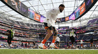 Cincinnati Bengals quarterback Joe Burrow looks at the field before the NFL Super Bowl 56 football game against the Los Angeles Rams Sunday, Feb. 13, 2022, in Inglewood, Calif. (AP Photo/Ted S. Warren)