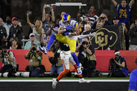 Los Angeles Rams wide receiver Cooper Kupp (10) is congratulated by teammates after scoring a touchdown against the Cincinnati Bengals during the second half of the NFL Super Bowl 56 football game Sunday, Feb. 13, 2022, in Inglewood, Calif. (AP Photo/Marcio Jose Sanchez)