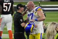 Cincinnati Bengals head coach Zac Taylor embraces Los Angeles Rams offensive tackle Andrew Whitworth (77) after the NFL Super Bowl 56 football game Sunday, Feb. 13, 2022, in Inglewood, Calif. The Los Angeles Rams won 23-20.(AP Photo/Tony Gutierrez)