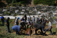 Relatives of 54-year-old woman Zilmar Batista, who died in the mudslides, bury her at the Municipal cemetery in Petropolis, Brazil, Thursday, Feb. 17, 2022. Deadly floods and mudslides swept away homes and cars, but even as families buried their dead, it was unclear how many bodies remained trapped in the mud. (AP Photo/Silvia Izquierdo)