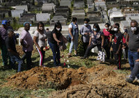 The remains of 54-year-old woman Zilmar Batista, who died in the mudslides, are buried at the Municipal cemetery in Petropolis, Brazil, Thursday, Feb. 17, 2022. Deadly floods and mudslides swept away homes and cars, but even as families buried their dead, it was unclear how many bodies remained trapped in the mud. (AP Photo/Silvia Izquierdo)