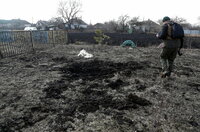 Luhansk (Ukraine), 23/02/2022.- A man looks at a shell hole after shelling in the Vibrovka village not far from the pro-Russian militants controlled city of Luhansk, Ukraine, 23 February 2022. Russia on 21 February 2022 recognized the eastern Ukrainian self-proclaimed Donetsk and Luhansk People's Republics breakaway regions as independent states and ordered the deployment of peacekeeping troops to the Donbas, triggering an expected series of economic sanctions announcements by Western countries.