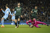 Sporting's Paulinho, right, gets past Manchester City's Conrad Jaden Egan-Riley during the Champions League round of 16 second leg soccer match between Manchester City and Sporting Lisbon at the City of Manchester Stadium in Manchester, England, Wednesday, March 9, 2022. (AP Photo/Dave Thompson)