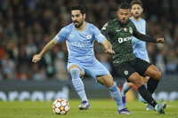 Sporting's Paulinho, right, gets past Manchester City's Conrad Jaden Egan-Riley during the Champions League round of 16 second leg soccer match between Manchester City and Sporting Lisbon at the City of Manchester Stadium in Manchester, England, Wednesday, March 9, 2022. (AP Photo/Dave Thompson)