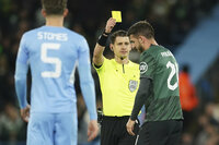Manchester City's Ilkay Gundogan, left, is challenged by Sporting's Bruno Tabata during the Champions League round of 16 second leg soccer match between Manchester City and Sporting Lisbon at the City of Manchester Stadium in Manchester, England, Wednesday, March 9, 2022. (AP Photo/Dave Thompson)