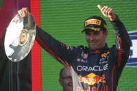Mercedes driver George Russell of Britain gestures as he holds his trophy after his third place finish at the Australian Formula One Grand Prix in Melbourne, Australia, Sunday, April 10, 2022. (AP Photo/Asanka Brendon Ratnayake)