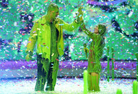 Hosts Rob Gronkowski, left, and Miranda Cosgrove get slimed at the conclusion of the Kids Choice Awards on Saturday, April 9, 2022, at the Barker Hangar in Santa Monica, Calif. (AP Photo/Chris Pizzello)