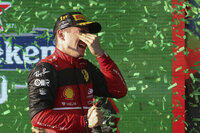 Ferrari driver Charles Leclerc of Monaco drinks champagne on the podium after winning the Australian Formula One Grand Prix in Melbourne, Australia, Sunday, April 10, 2022. (AP Photo/Asanka Brendon Ratnayake)