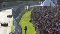 Spectators watch the trophy presentation at the Australian Formula One Grand Prix in Melbourne, Australia, Sunday, April 10, 2022. (AP Photo/Asanka Brendon Ratnayake)