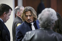 Johnny Depp stands inside a courtroom at the Fairfax County Circuit Court, Tuesday, April 12, 2022, in Fairfax, Va. A jury in Virginia is scheduled to hear opening statements Tuesday in a defamation lawsuit filed by Johnny Depp against his ex-wife, Amber Heard. (Brendan Smialowski/Pool Photo via AP)