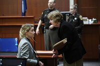 US actress Amber Heard speaks with her lawyer Elaine Bredehoft during the $50 million Depp vs Heard deformation trail at the Fairfax County Circuit Court April 12, 2022, in Fairfax, Virginia. - 'Pirates of the Caribbean' star Johnny Depp physically and sexually abused his then-wife Amber Heard during drug- and alcohol-fueled binges in which he became a 'monster,' her lawyers told a court on Tuesday. (Photo by Brendan SMIALOWSKI / POOL / AFP)