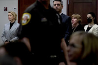 Actress Amber Heard left, listens inside the courtroom at the Fairfax County Circuit Court, April 12, 2022, in Fairfax, Va. A jury in Virginia is scheduled to hear opening statements in a defamation lawsuit filed by Johnny Depp against his ex-wife, Amber Heard. (Brendan Smialowski, Pool via AP)