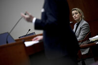 Actress Amber Heard listens inside the courtroom at the Fairfax County Circuit Court, April 12, 2022, in Fairfax, Va. A jury in Virginia is scheduled to hear opening statements in a defamation lawsuit filed by Johnny Depp against his ex-wife, Amber Heard. (Brendan Smialowski, Pool via AP)