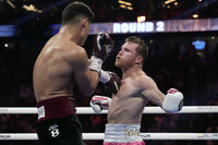 Dmitry Bivol, right, of Kyrgyzstan, throws a punch against Canelo Alvarez, of Mexico, during a light heavyweight title fight, Saturday, May 7, 2022, in Las Vegas. (AP Photo/John Locher)