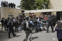 Israeli police confront mourners and journalists covering the funeral of slain Al Jazeera veteran journalist Shireen Abu Akleh in east Jerusalem, Friday, May 13, 2022. Abu Akleh, a Palestinian-American reporter who covered the Mideast conflict for more than 25 years, was shot dead Wednesday during an Israeli military raid in the West Bank town of Jenin. (AP Photo/Mahmoud Illean)