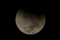 A lunar eclipse graces the night sky during the first blood moon of the year, in Mexico City, Sunday, May 15, 2022. (AP Photo/Fernando Llano)