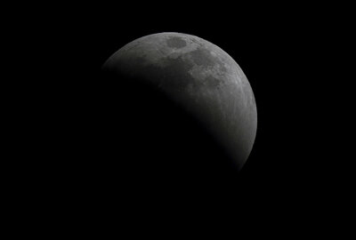 A lunar eclipse graces the night sky during the first blood moon of the year, in Mexico City, Sunday, May 15, 2022. (AP Photo/Fernando Llano)
