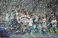 Real Madrid players celebrate with the trophy winning the Champions League final soccer match between Liverpool and Real Madrid at the Stade de France in Saint Denis near Paris, Saturday, May 28, 2022. Real Madrid won 1-0. (AP Photo/Kirsty Wigglesworth)