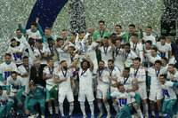 Real Madrid players hold the trophy and celebrate after winning the Champions League final soccer match between Liverpool and Real Madrid at the Stade de France in Saint Denis near Paris, Saturday, May 28, 2022. (AP Photo/Christophe Ena)