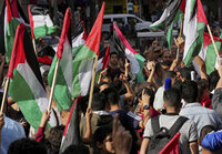 Hamas supporters wave Palestinian flags during a protest against the Israeli flags march to mark Jerusalem Day, an Israeli holiday celebrating the capture of the Old City of Jerusalem during the 1967 Mideast war, in the Jebaliya refugee camp, northern Gaza Strip, Sunday, May 29, 2022. (AP Photo/Adel Hana)