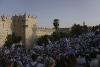 Israelis wave national flags in front of Damascus Gate outside Jerusalem's Old City to mark Jerusalem Day, an Israeli holiday celebrating the capture of the Old City during the 1967 Mideast war. Sunday, May 29, 2022. Israel claims all of Jerusalem as its capital. But Palestinians, who seek east Jerusalem as the capital of a future state, see the march as a provocation. Last year, the parade helped trigger an 11-day war between Israel and Gaza militants. (AP Photo/Ariel Schalit)