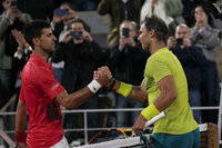 Serbia's Novak Djokovic, left, congratulates Spain's Rafael Nadal who won the quarterfinal match in four sets, 6-2, 4-6, 6-2, 7-6 (7-4), at the French Open tennis tournament in Roland Garros stadium in Paris, France, Wednesday, June 1, 2022. (AP Photo/Christophe Ena)
